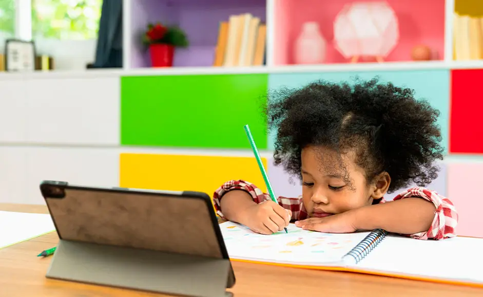 A child working through a printed worksheet at a table
